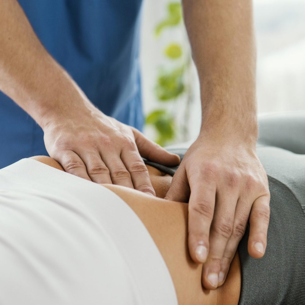 male-osteopathic-therapist-checking-female-patient-s-abdomen